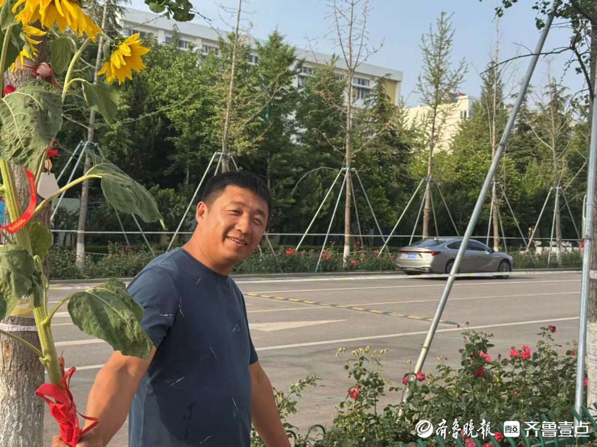 带着泥土的芬芳！父亲手捧自己种的向日葵在高考考点外接娃