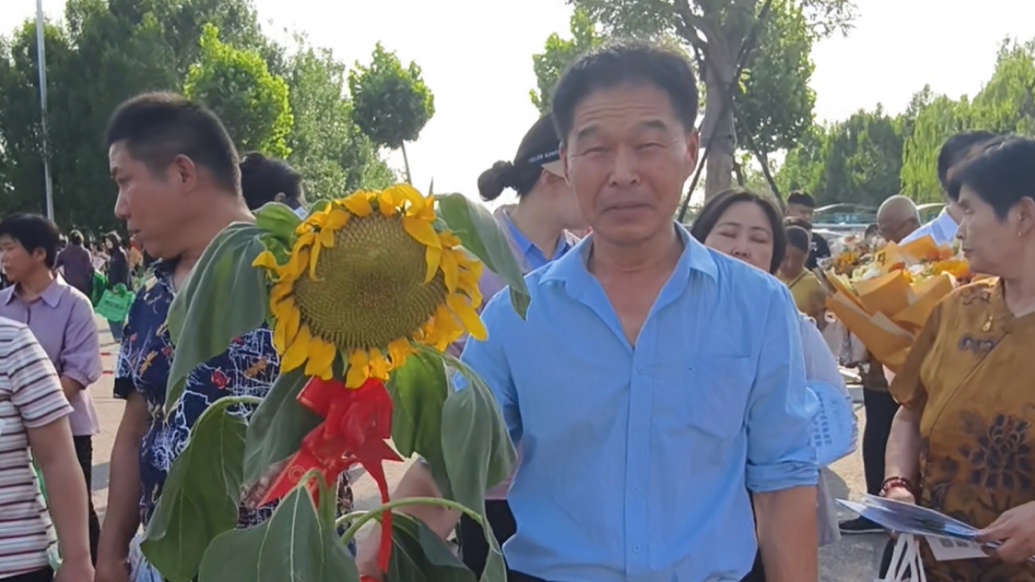 真向日葵！一位家长带来了自己种植的向日葵来接孩子