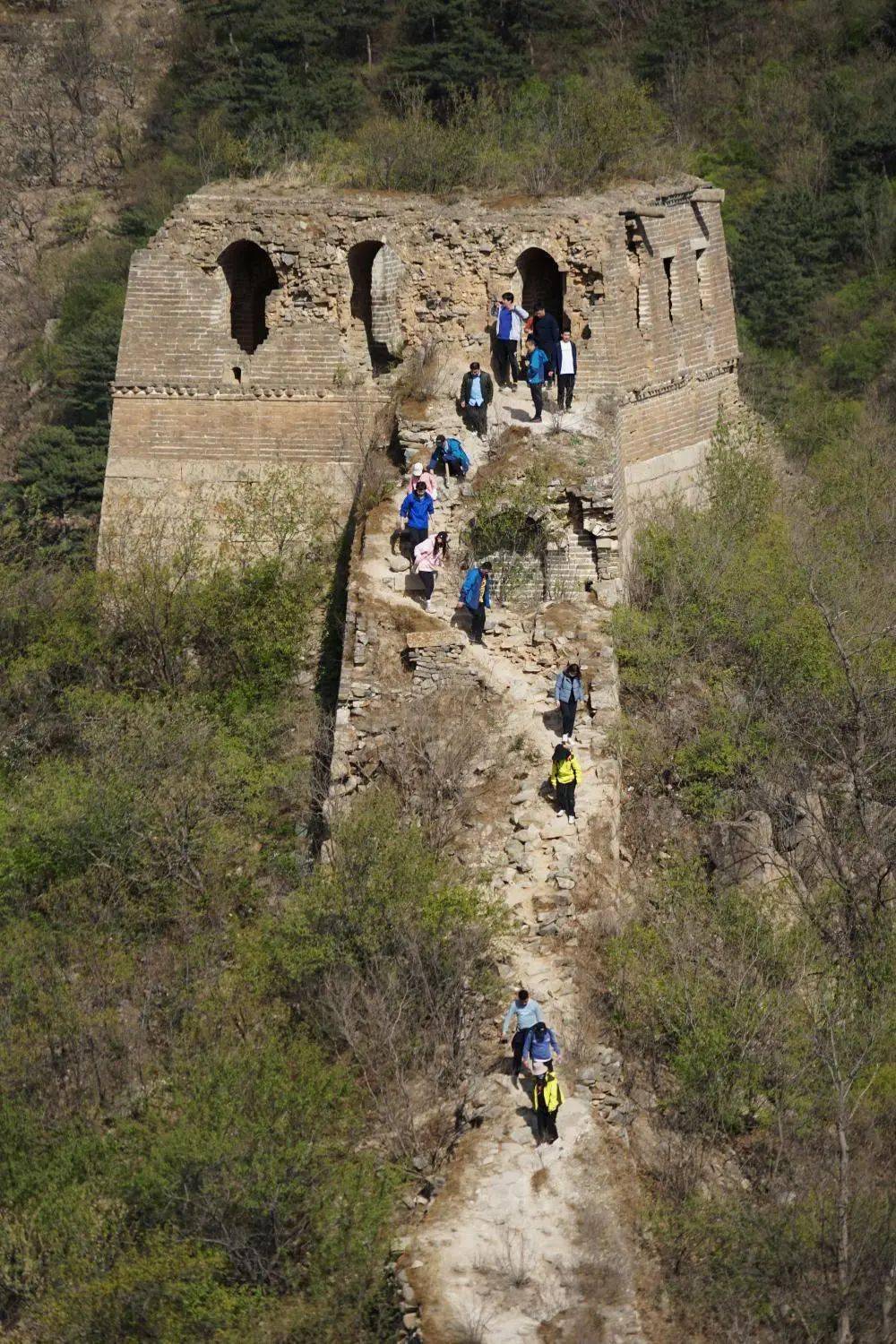 4月17日,游客从撞道口段野长城某个烽火台鱼贯而出.