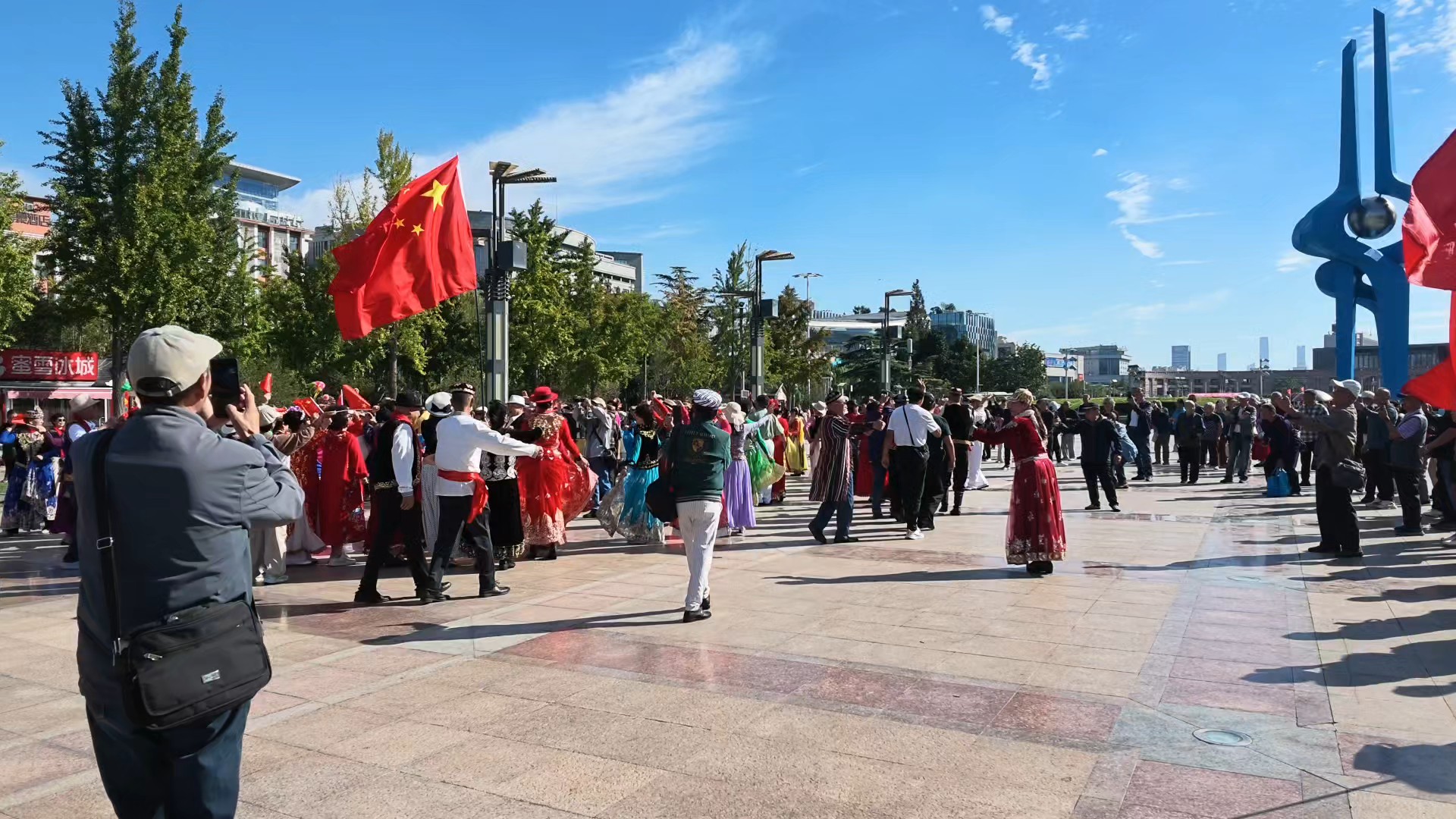 国庆节市民们纷纷涌进泉城广场，高举国旗载歌载舞庆国庆。